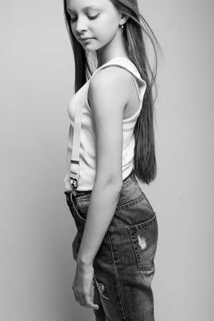Beautiful child. Little girl in black and white studio. High quality photo.の写真素材