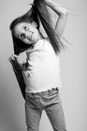 Beautiful child. Little girl in black and white studio. High quality photo.の写真素材