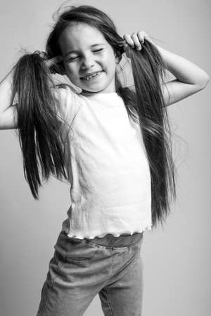 Beautiful child. Little girl in black and white studio. High quality photo.の写真素材