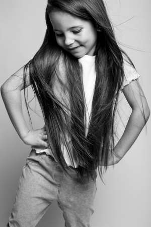 Beautiful child. Little girl in black and white studio. High quality photo.の写真素材