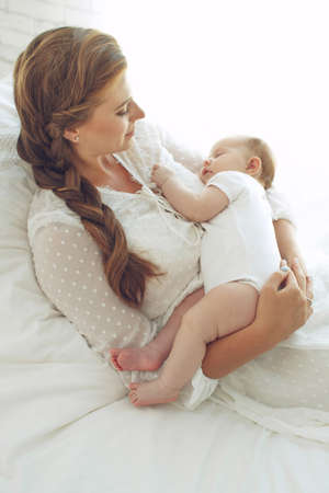 Small child with a woman. Baby with mom. High quality photo.の写真素材