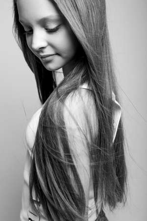 Beautiful child. Little girl in black and white studio. High quality photo.の写真素材