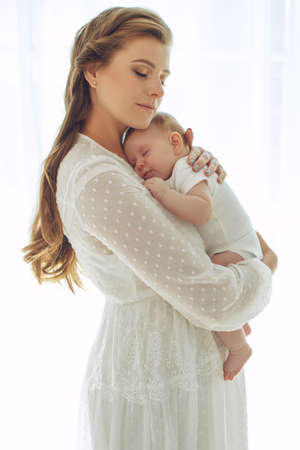 Small child with a woman. Baby with mom. High quality photo.の写真素材