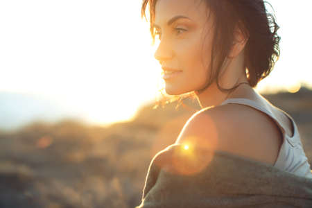 Beautiful woman. Portrait of a beautiful young girl at sunset. High quality photo.の写真素材
