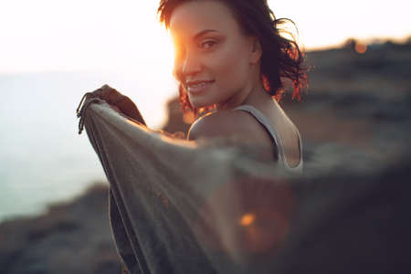 Beautiful woman. Portrait of a young woman in nature with sunset light. High quality photo.の写真素材