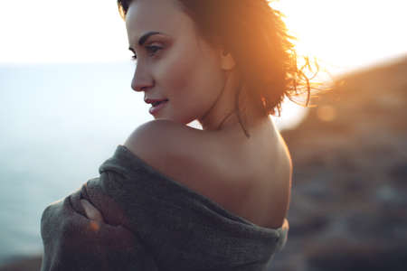 Beautiful woman. Portrait of a young woman in nature with sunset light. High quality photo.の写真素材