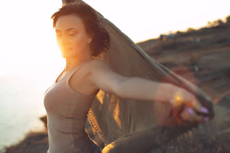 Beautiful woman. Portrait of a young woman in nature with sunset light. High quality photo.の写真素材