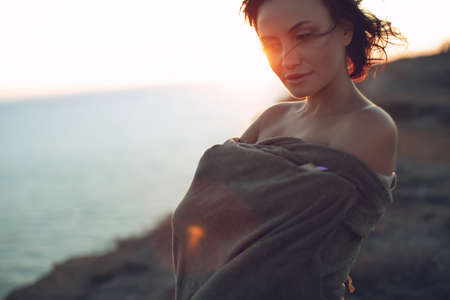 Beautiful woman. Portrait of a young woman in nature with sunset light. High quality photo.の写真素材