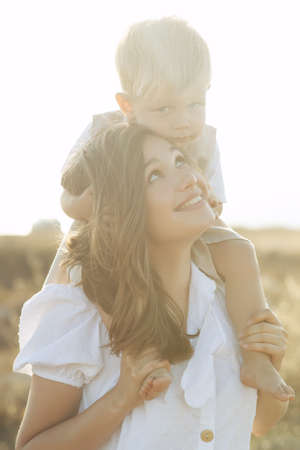 Beautiful woman with a child in nature. High quality photo.の写真素材