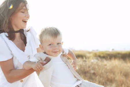 Beautiful woman with a child in nature. High quality photo.の写真素材