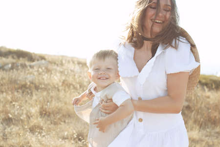 Beautiful woman with a child in nature. High quality photo.の写真素材