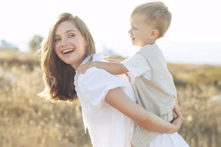 Beautiful woman with a child in nature. High quality photo.の写真素材