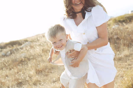 Beautiful woman with a child in nature. High quality photo.の写真素材