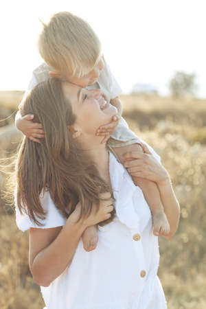 Beautiful woman with a child in nature. High quality photo.の写真素材