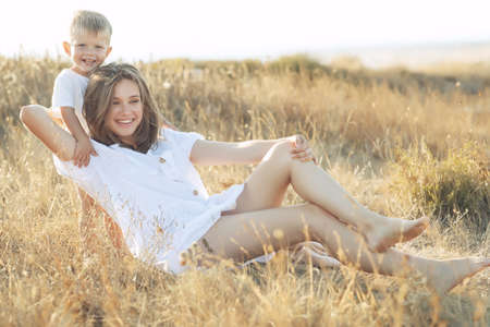 Beautiful woman with a child in nature. High quality photo.の写真素材