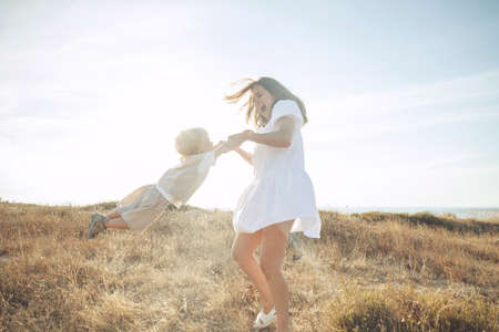 Beautiful woman with a child in nature. High quality photo.の写真素材