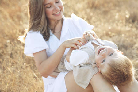 Beautiful woman with a child in nature. High quality photo.の写真素材