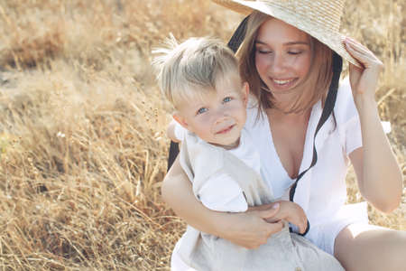 Beautiful woman with a child in nature. High quality photo.の写真素材