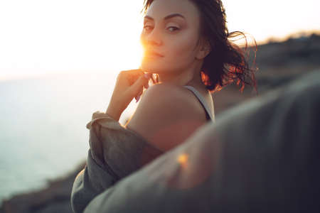 Beautiful woman. Portrait of a young woman in nature with sunset light. High quality photo.の写真素材