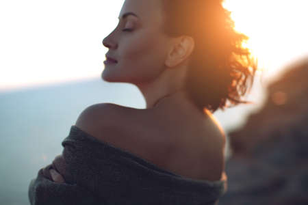 Beautiful woman. Portrait of a young woman in nature with sunset light. High quality photo.の写真素材