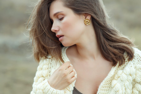 Beautiful woman wearing a sweater. Young girl in nature. High quality photo.の写真素材
