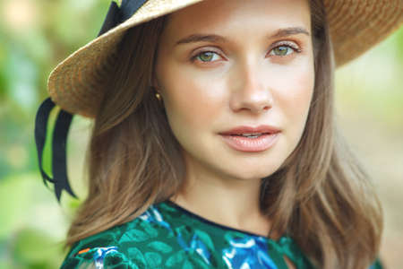 Beautiful woman in nature. Young girl in a hat. High quality photo.の写真素材