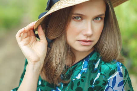 Beautiful woman in nature. Young girl in a hat. High quality photo.の写真素材