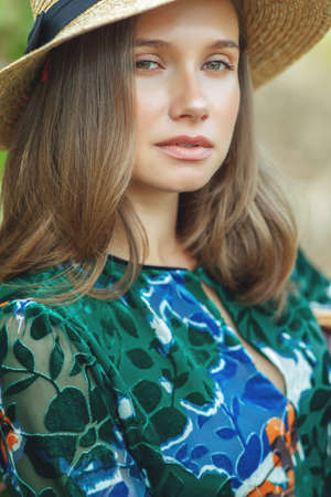 Beautiful woman in nature. Young girl in a hat. High quality photo.の写真素材