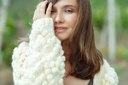 Beautiful woman wearing a sweater. Young girl in nature. High quality photo.の写真素材