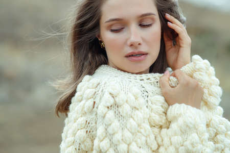 Beautiful woman wearing a sweater. Young girl in nature. High quality photo.の写真素材