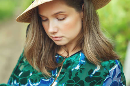 Beautiful woman in nature. Young girl in a hat. High quality photo.の写真素材