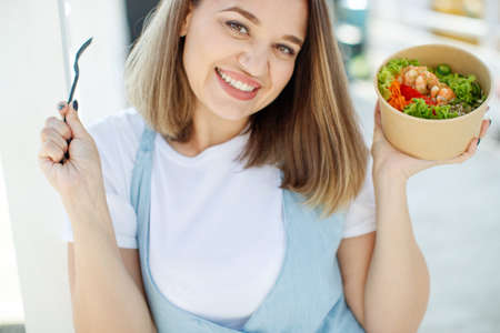 The woman is on the right diet. Fat woman eats salad. High quality photo.の写真素材