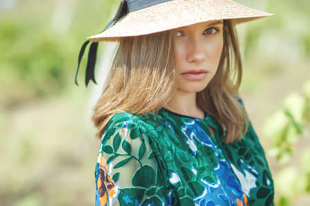 Beautiful woman in nature. Young girl in a hat. High quality photo.の写真素材