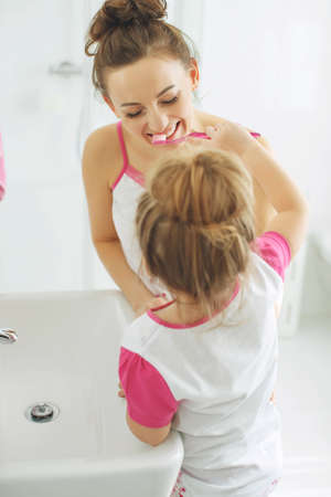 Mom and child brush their teeth. High quality photo.の写真素材
