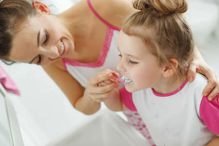 Mom and child brush their teeth. High quality photo.の写真素材