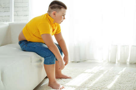 A boy with metabolic disorders. Child with the problem of childhood obesity. Overweight obese fat boy. High quality photo.の写真素材