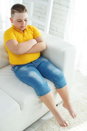 A boy with metabolic disorders. Child with the problem of childhood obesity. Overweight obese fat boy. High quality photo.の写真素材