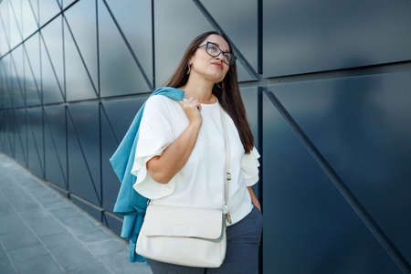 Young fat stylish woman on a city street. Spring fashion outfit, elegant look. Plus size model. High quality photo.の写真素材