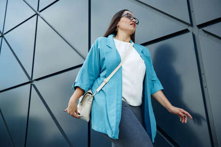 Young fat stylish woman on a city street. Spring fashion outfit, elegant look. Plus size model. High quality photo.の写真素材