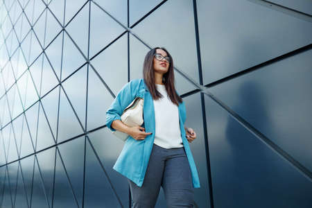 Young fat stylish woman on a city street. Spring fashion outfit, elegant look. Plus size model. High quality photo.の写真素材