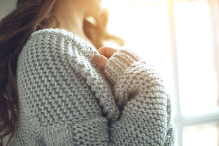 Young beautiful woman in warm knitted clothes at home. Female indoor portrait. High quality photo.の写真素材