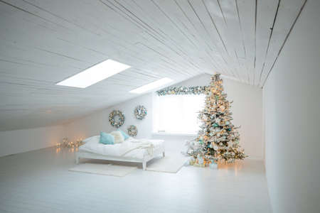 Beautiful holiday decorated room with a Christmas tree with gifts under it. High quality photo.の写真素材