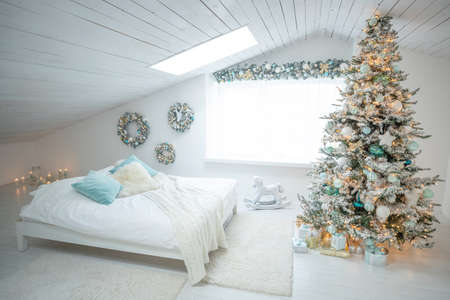 Beautiful holiday decorated room with a Christmas tree with gifts under it. High quality photo.の写真素材
