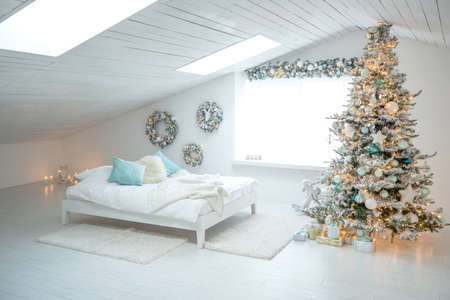 Beautiful holiday decorated room with a Christmas tree with gifts under it. High quality photo.の写真素材