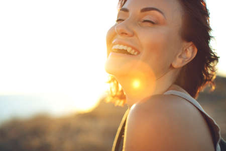 Portrait of a beautiful girl close-up, wind fluttering hair.Young smiling woman outdoors portrait. High quality photo.の写真素材