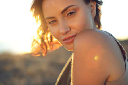 Portrait of a beautiful girl close-up, wind fluttering hair.Young smiling woman outdoors portrait. High quality photo.の写真素材
