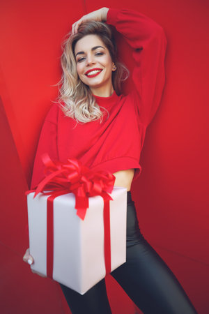 Beautiful young sexy woman slim figure evening makeup fashionable stylish clothes, brunette, gift boxes holiday birthday New Year Christmas Valentines Day. High quality photo.の写真素材