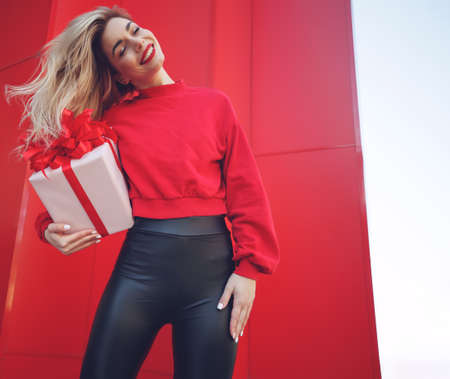 Beautiful young sexy woman slim figure evening makeup fashionable stylish clothes, brunette, gift boxes holiday birthday New Year Christmas Valentines Day. High quality photo.の写真素材