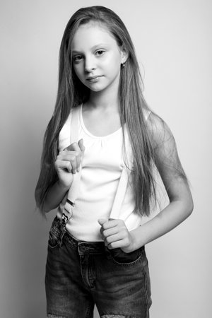 Beautiful child. Little girl in black and white studio. High quality photo.の写真素材