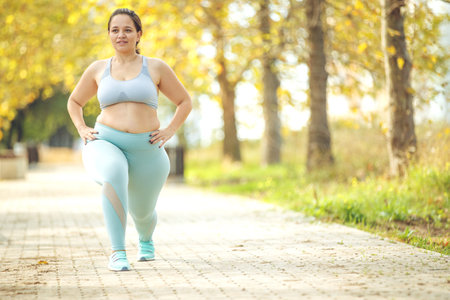 Fat woman jogging, doing sports for weight loss, obesity problem. High quality photo.の写真素材